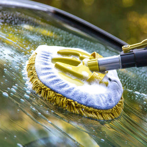 cleaning head in use cleaning windshield