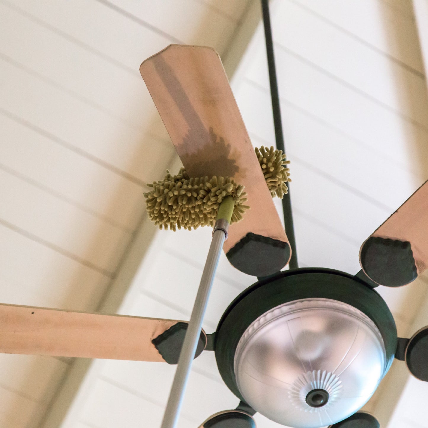 flex fan duster in action cleaning ceiling fan